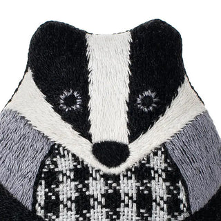 close up of badger embroidery plushie